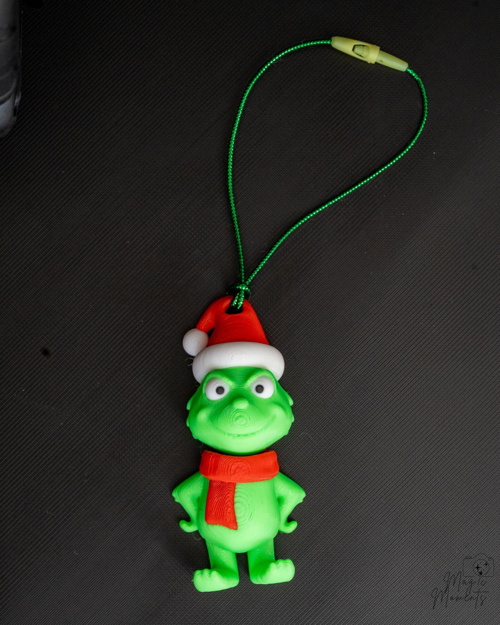 Green Christmas character ornament with Santa hat and hanging loop