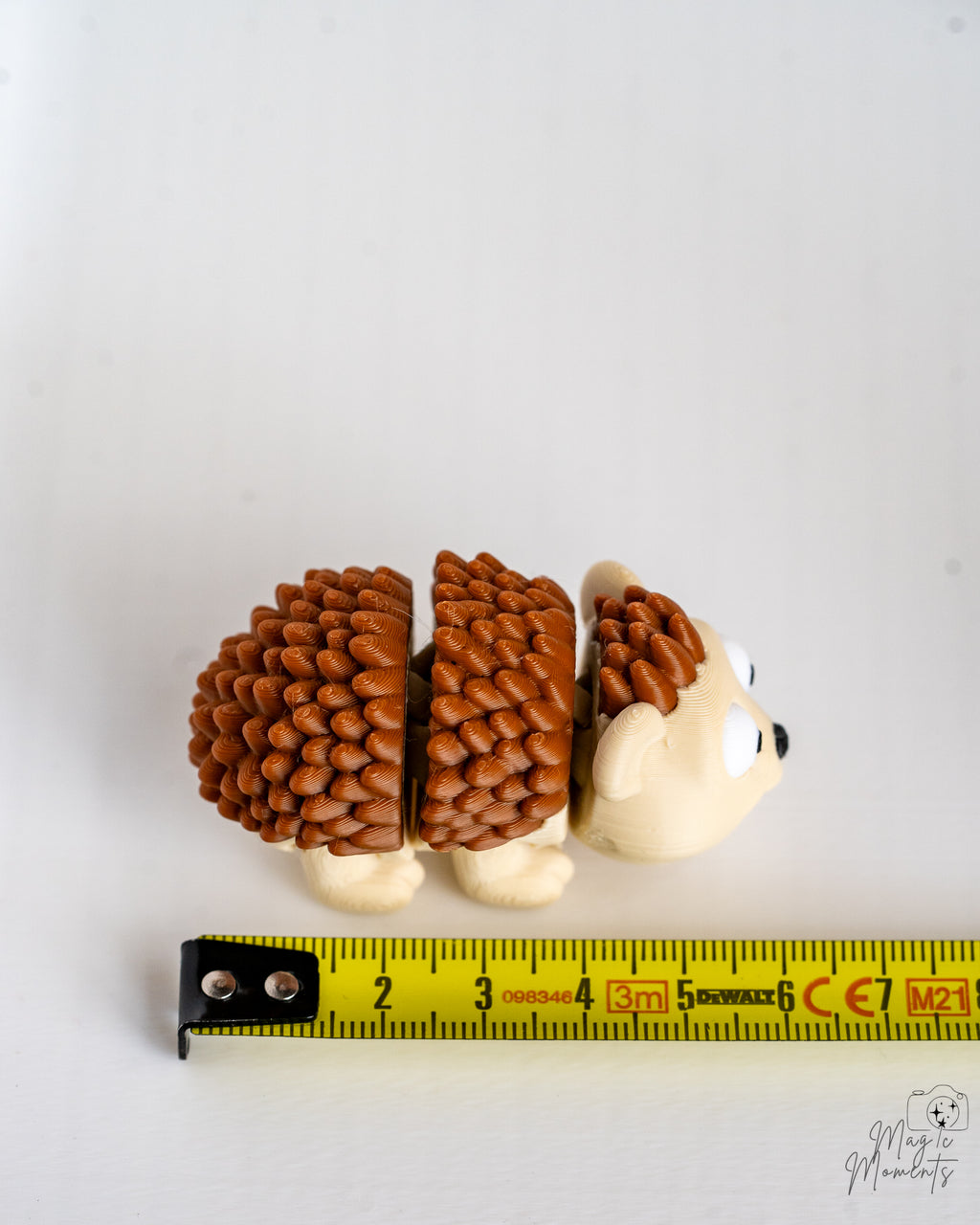Hedgehog figure next to measuring tape for scale