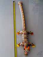 Gingerbread dragon figure next to measuring tape for scale