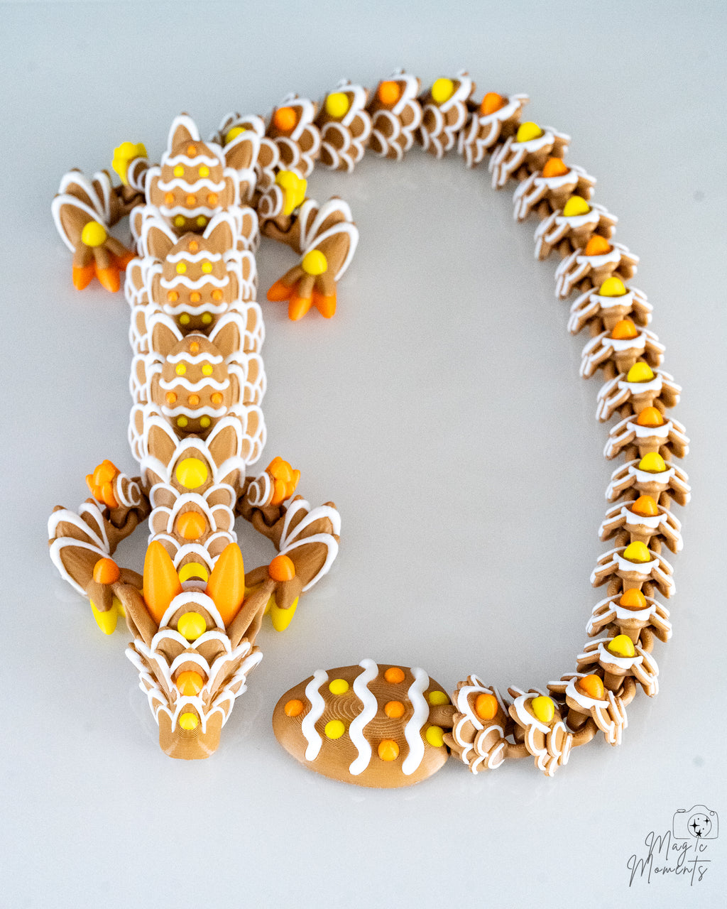 Articulated gingerbread style dragon in brown white and orange colours