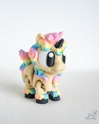 Cute rainbow unicorn figurine viewed from front angle