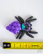 Grape spider next to measuring tape for scale