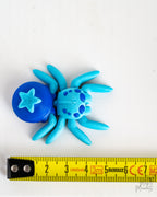 Blueberry spider next to measuring tape for scale
