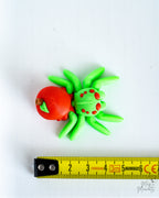 Apple spider next to measuring tape for scale