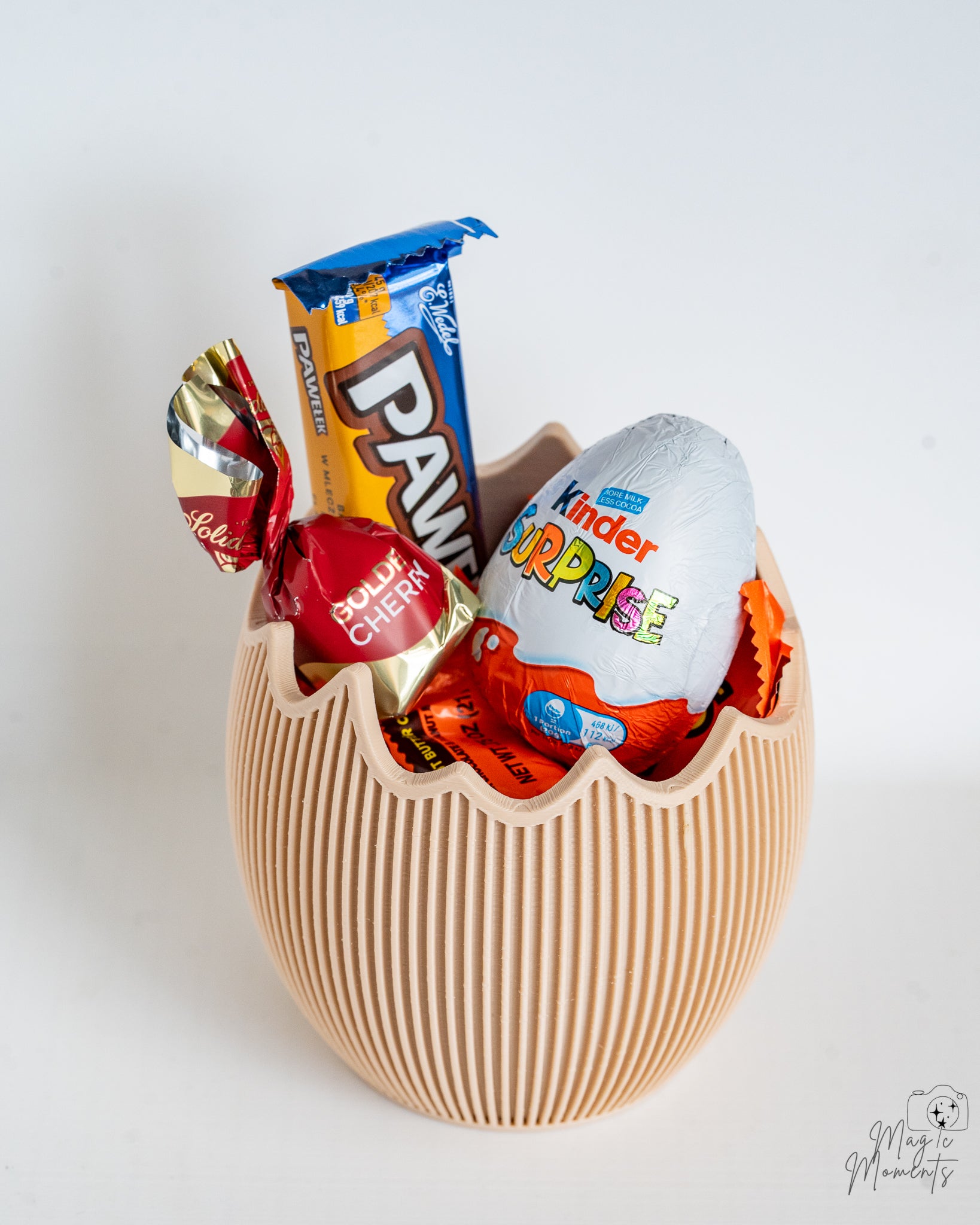 Egg shaped container filled with sweets and chocolate