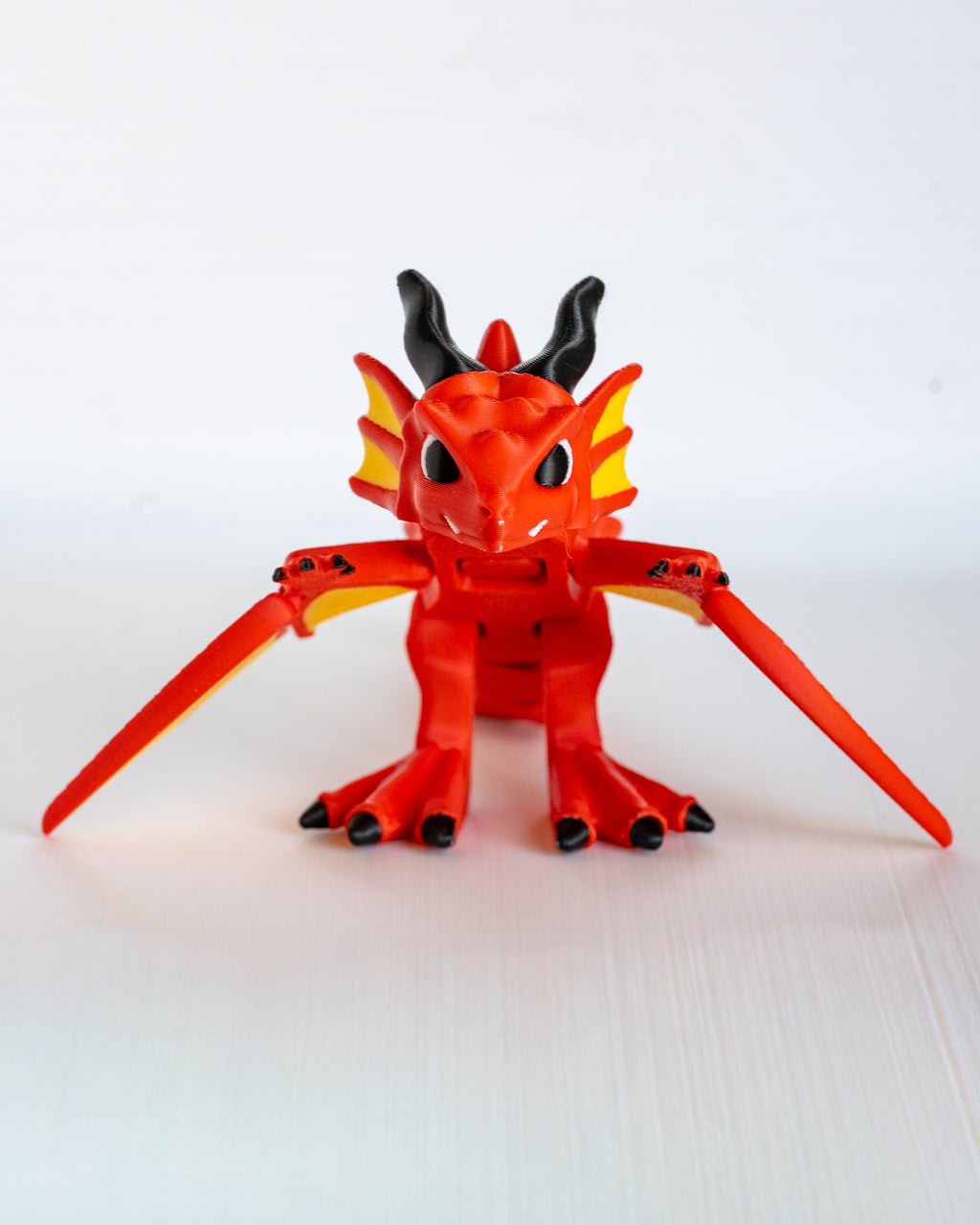 Winged dragon figure viewed from front