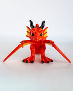 Winged dragon figure viewed from front