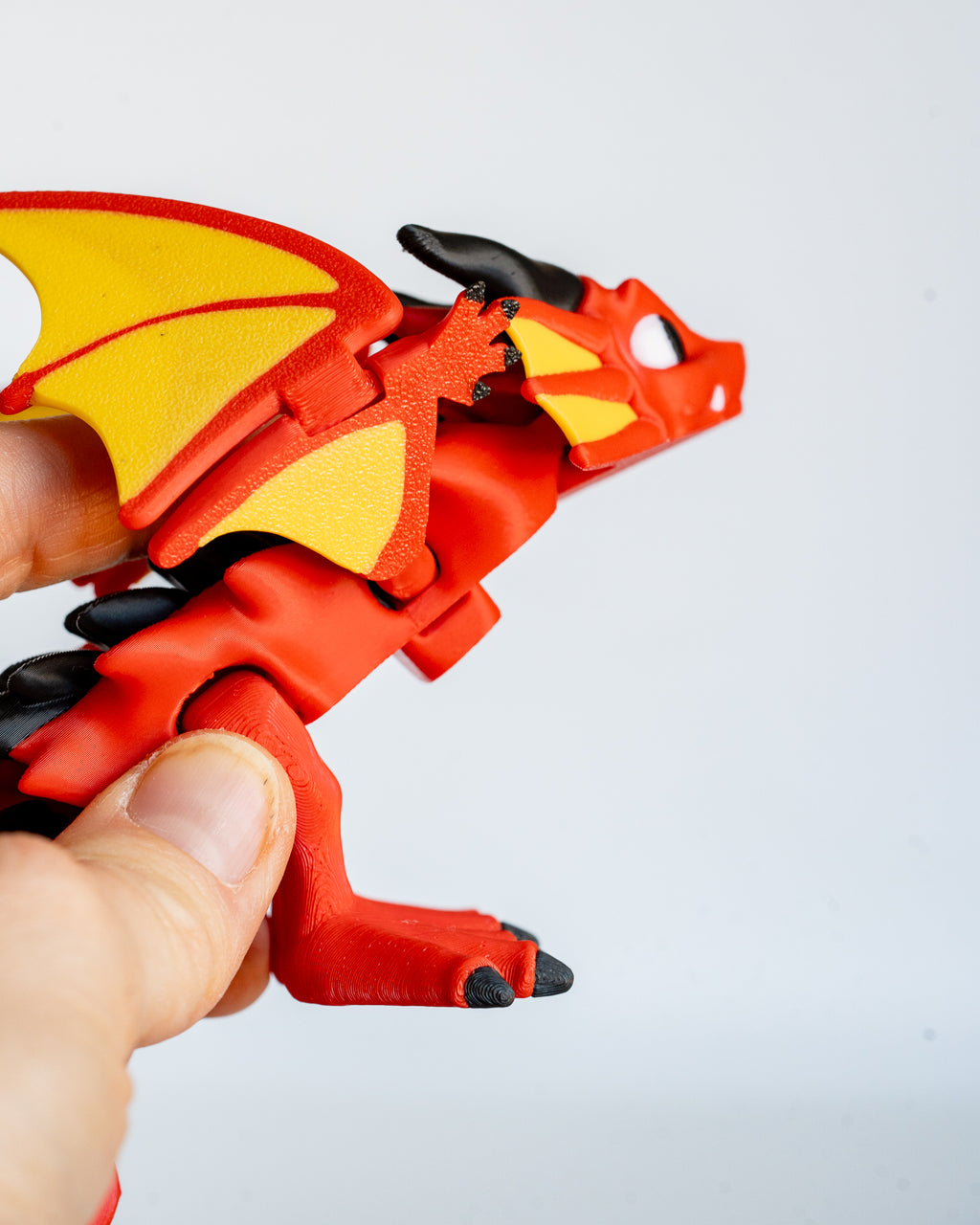 Red dragon figure held in hand