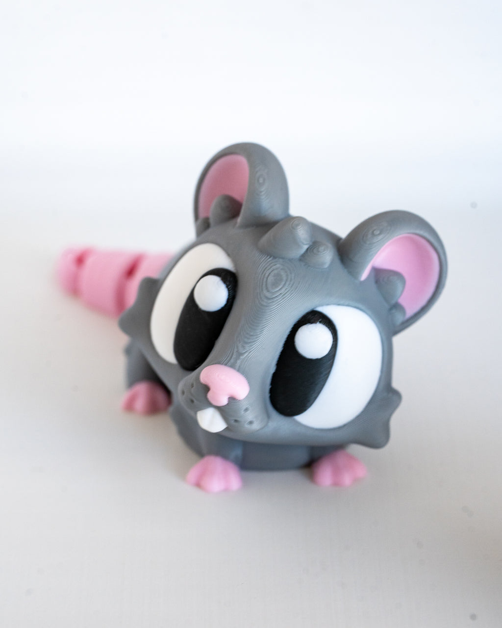 Mini mouse figurine with cartoon eyes