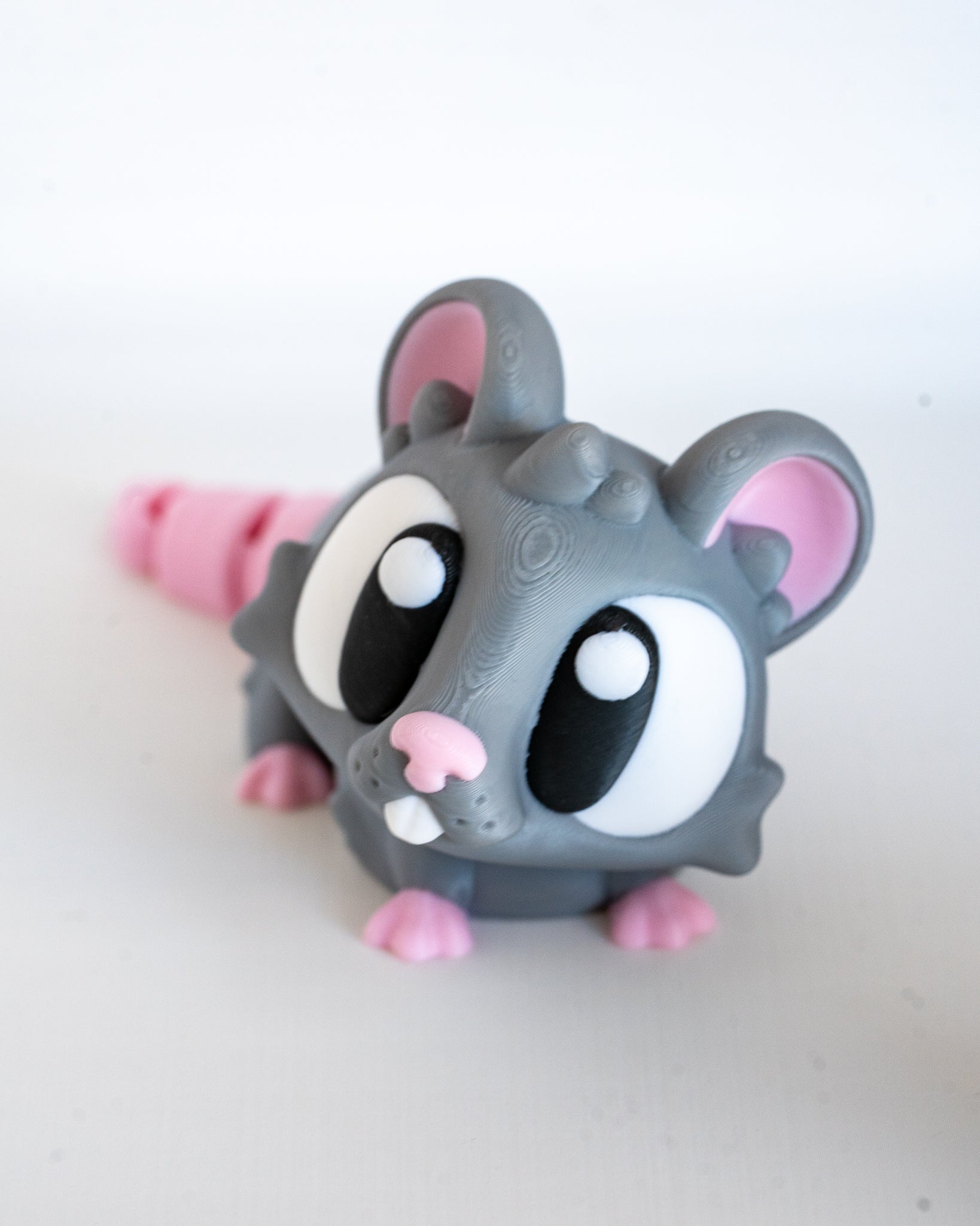 Mini mouse figurine with cartoon eyes