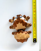 Spider figure next to measuring tape for scale