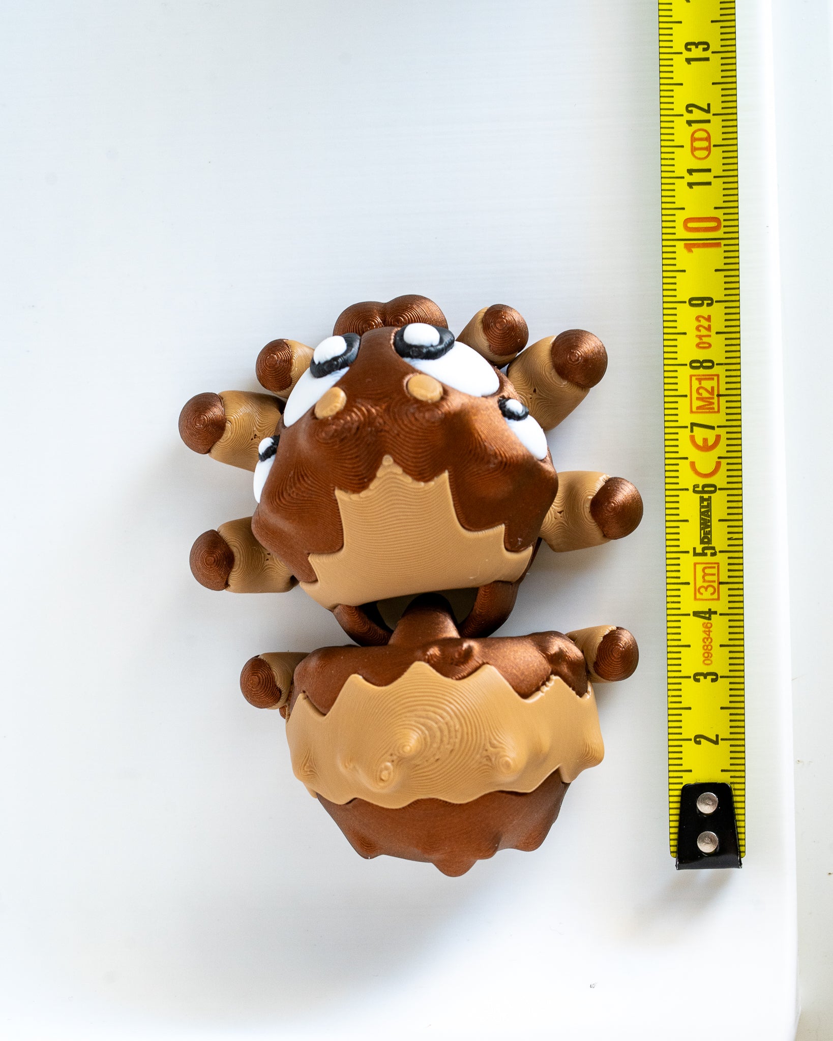 Spider figure next to measuring tape for scale