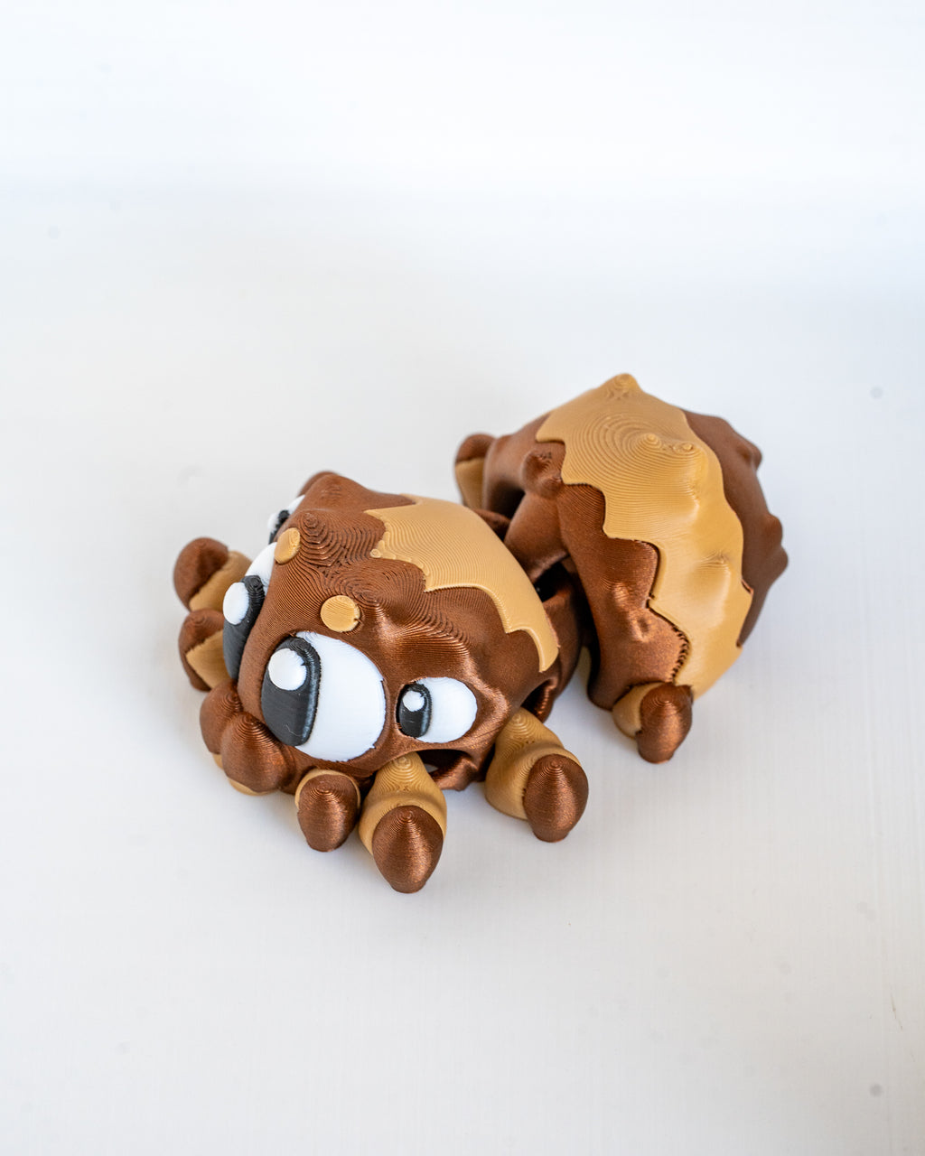 Spider figure curled up viewed from side