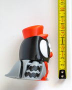 Postman pigeon figure next to measuring tape for scale