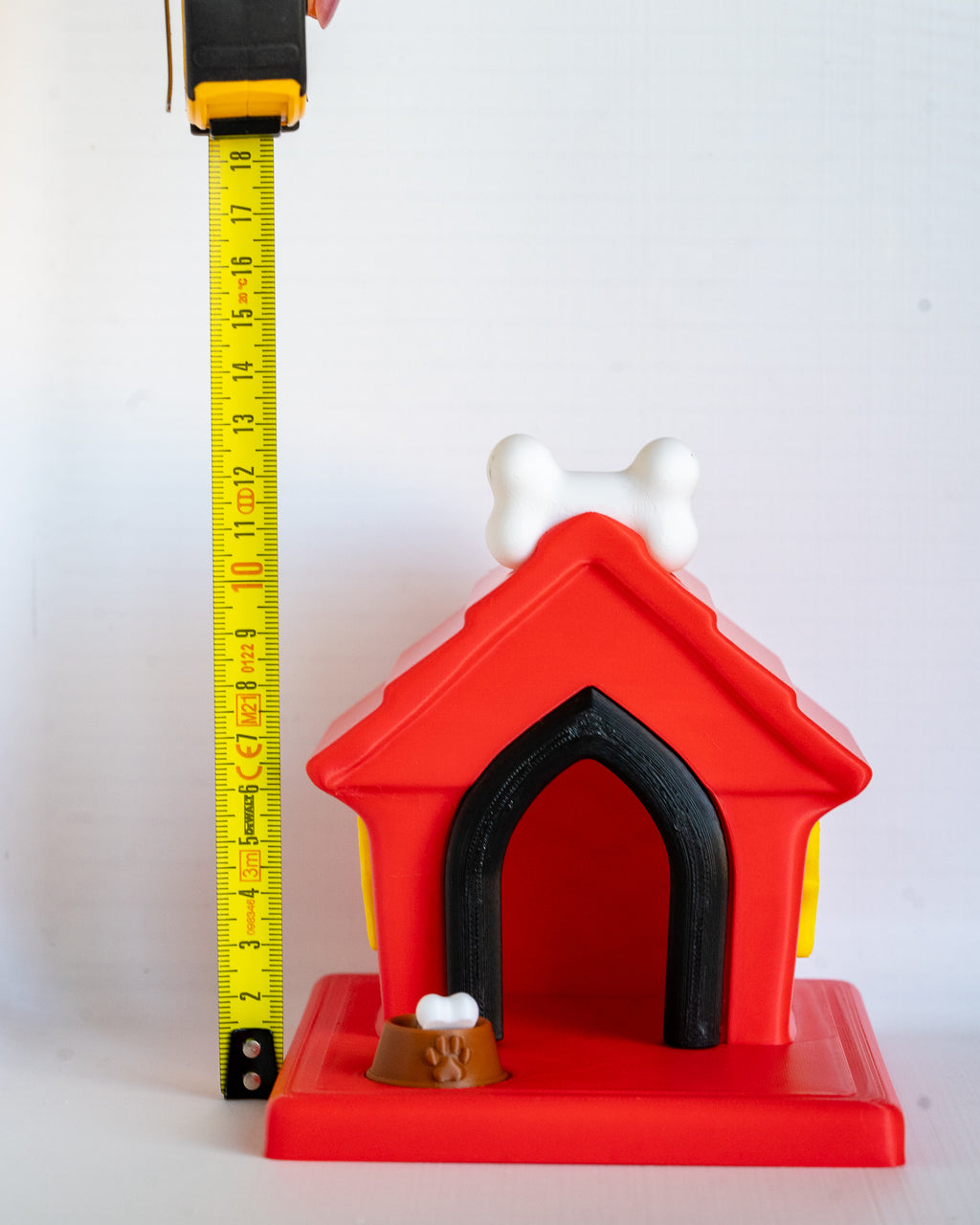 Dog house next to measuring tape for scale