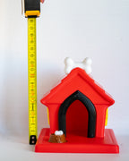 Dog house next to measuring tape for scale