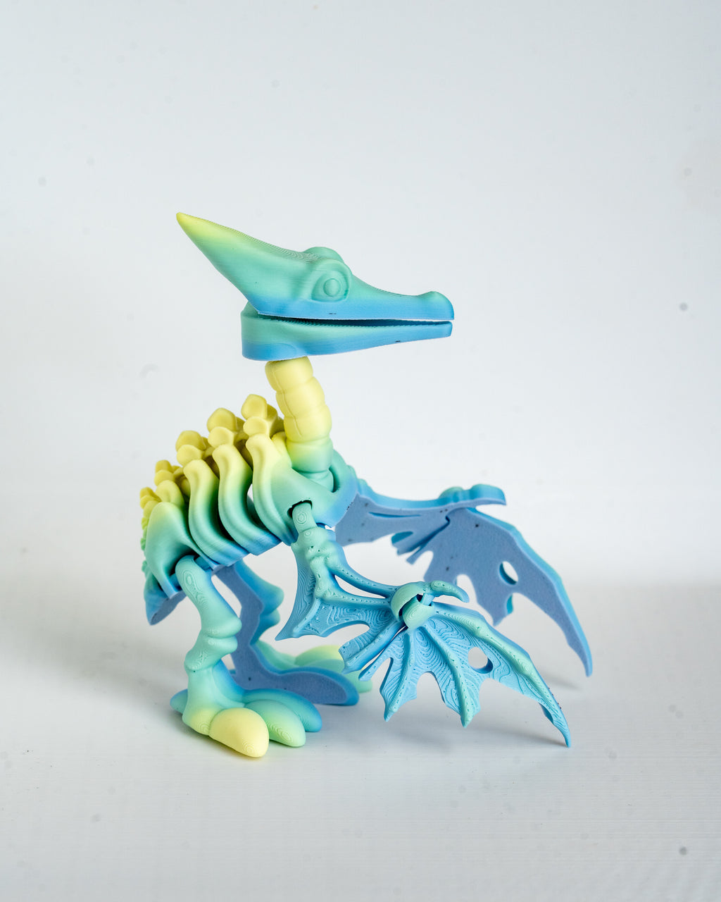 Blue pastel pterodactyl skeleton viewed from side