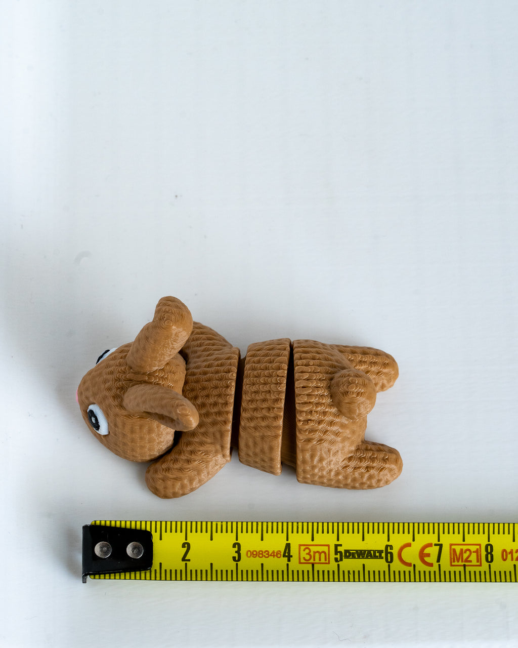 Bunny decorative figure next to measuring tape for scale