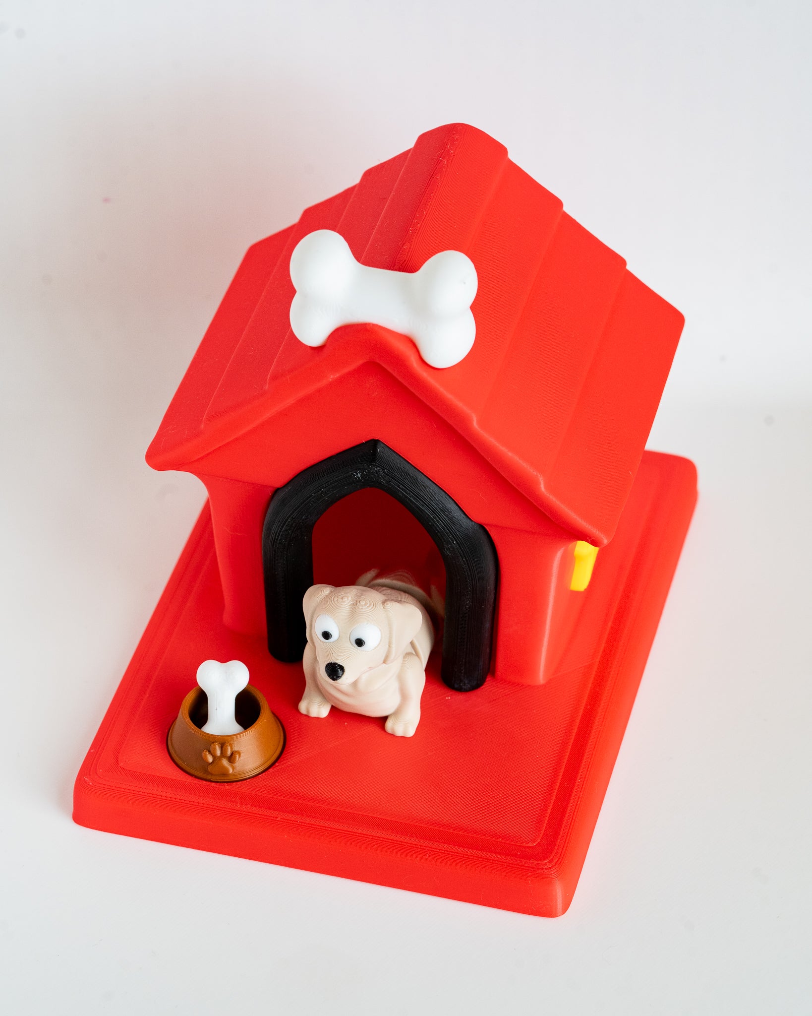 Dog house with beige labrador puppy figure inside
