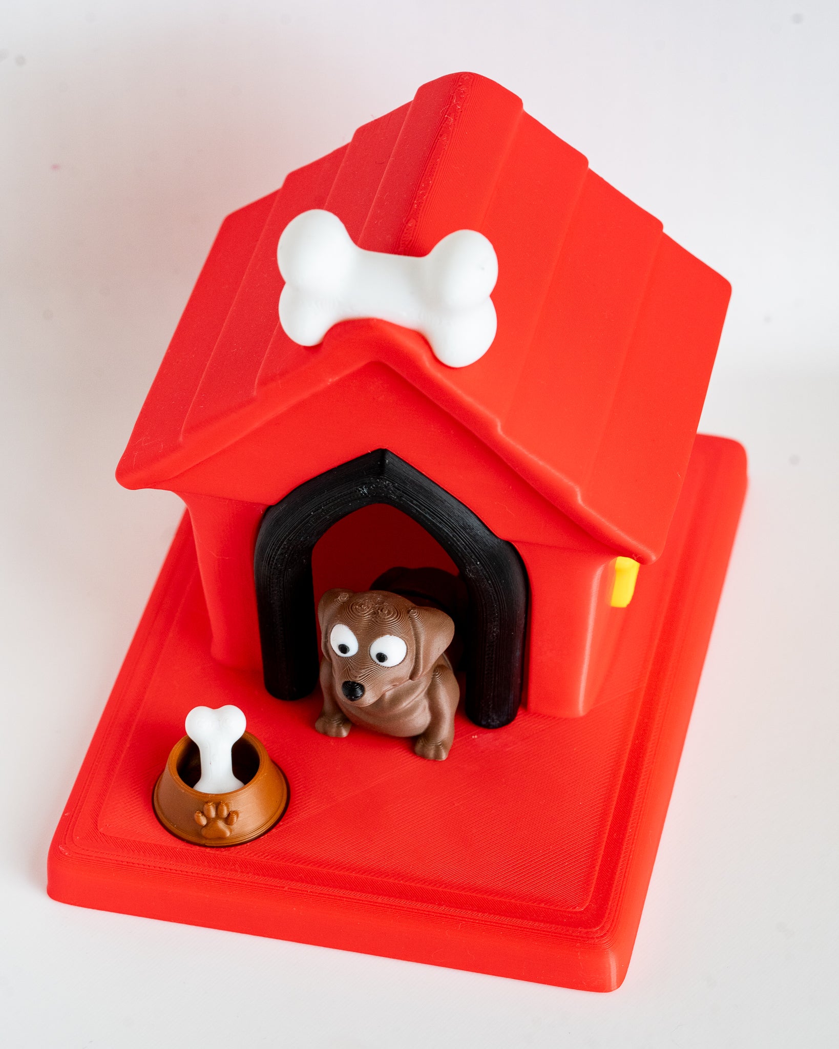 Dog house with chocolate labrador puppy figure inside