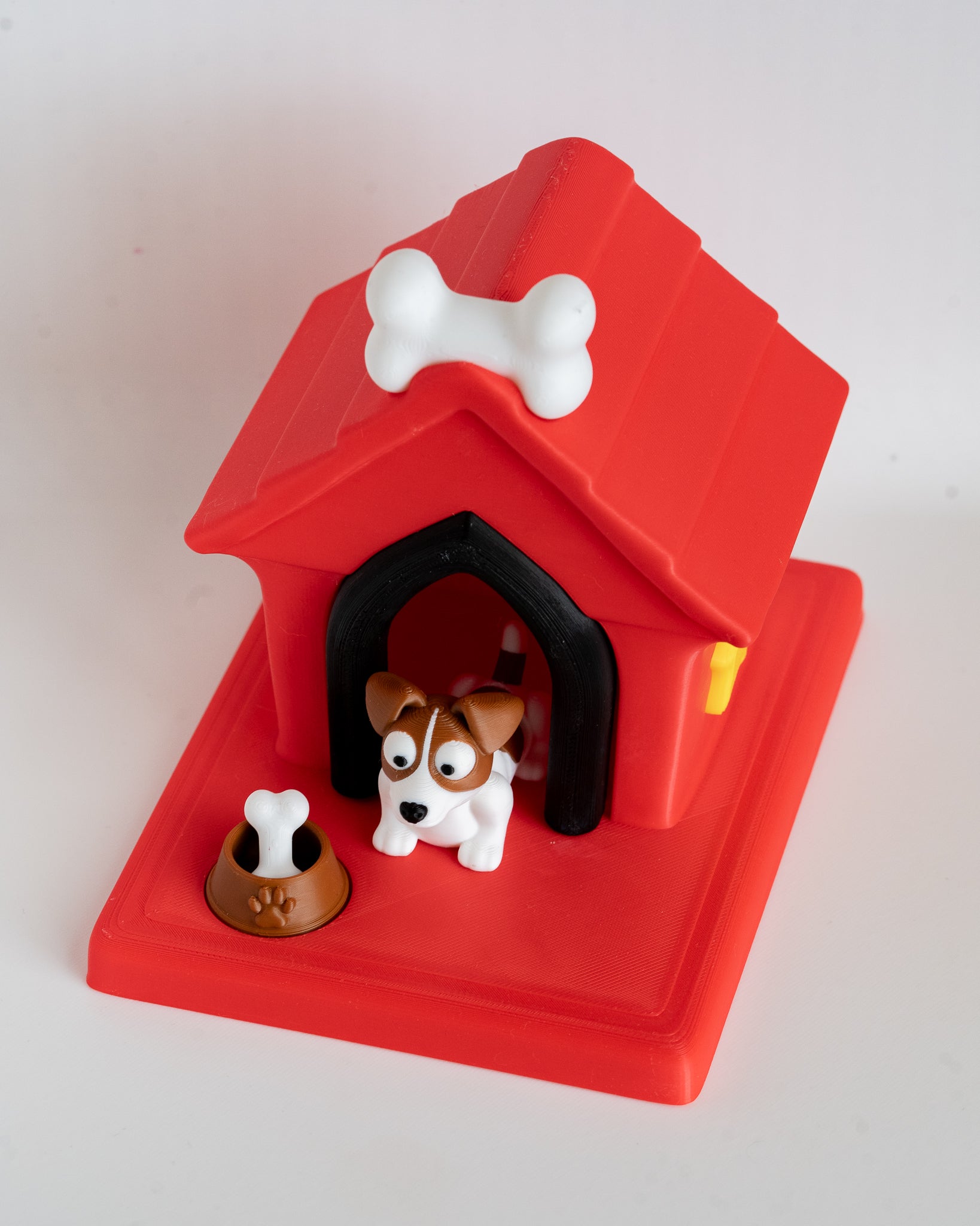 Dog house with jack russell terrier puppy figure inside