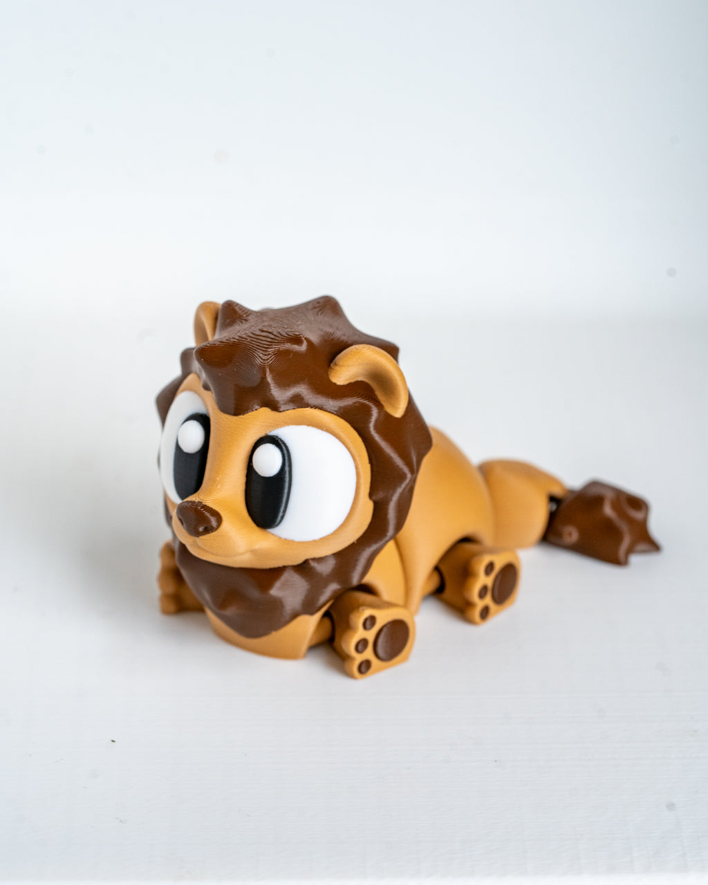 Mini lion figurine with cartoon eyes