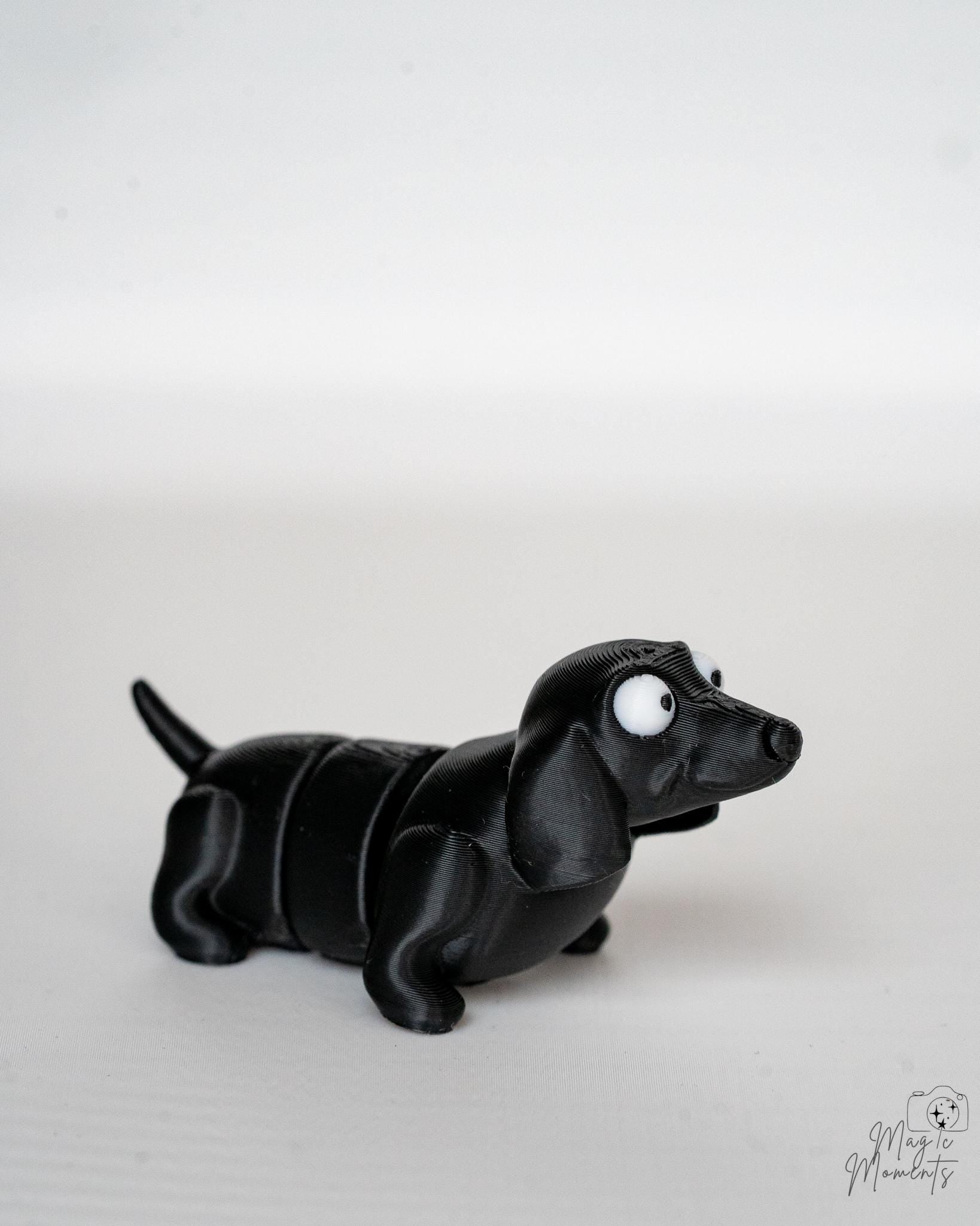 Cute black articulated dog figure