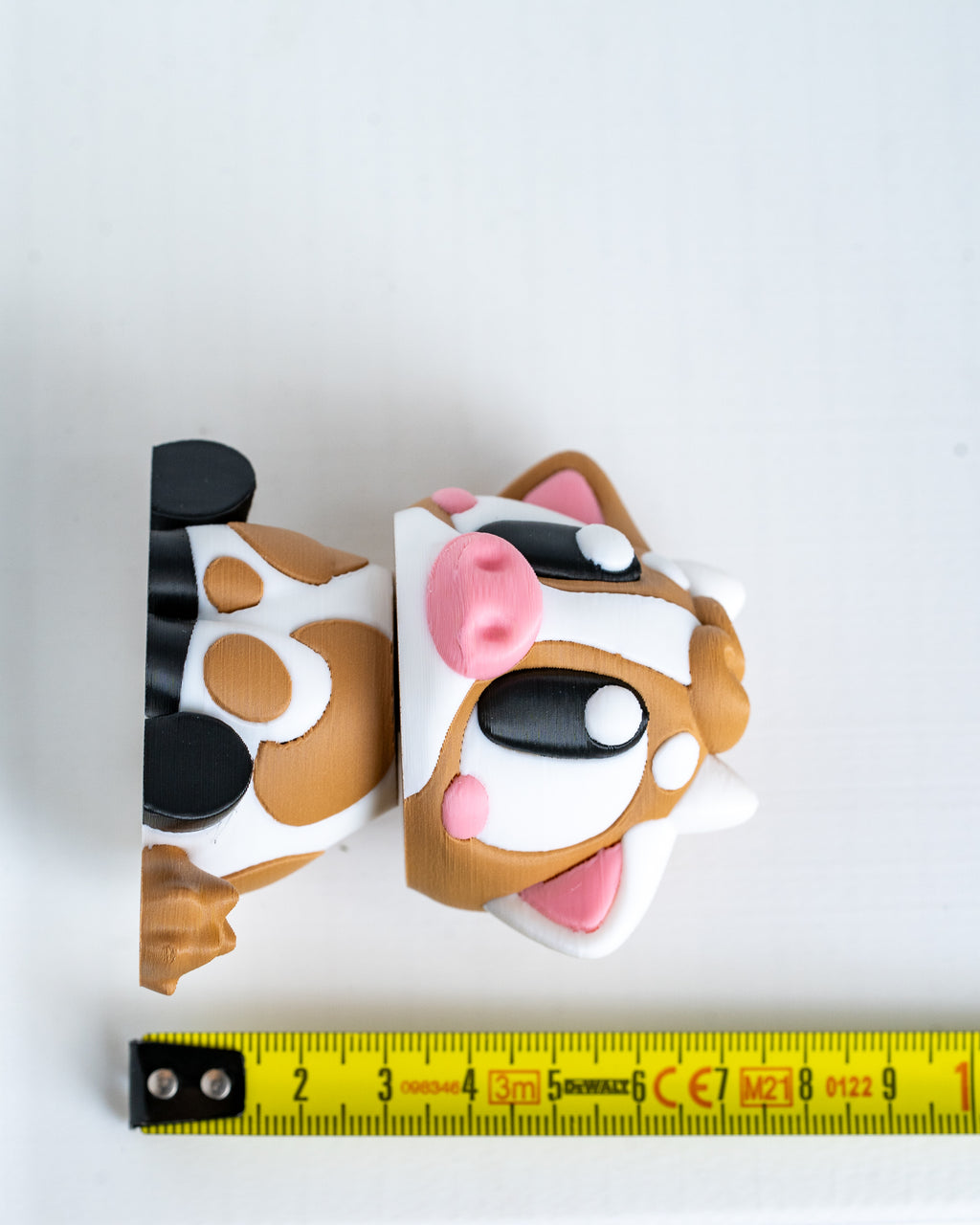 Cow figure next to measuring tape for scale