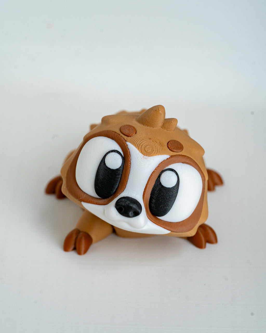 Mini sloth figurine with cartoon eyes