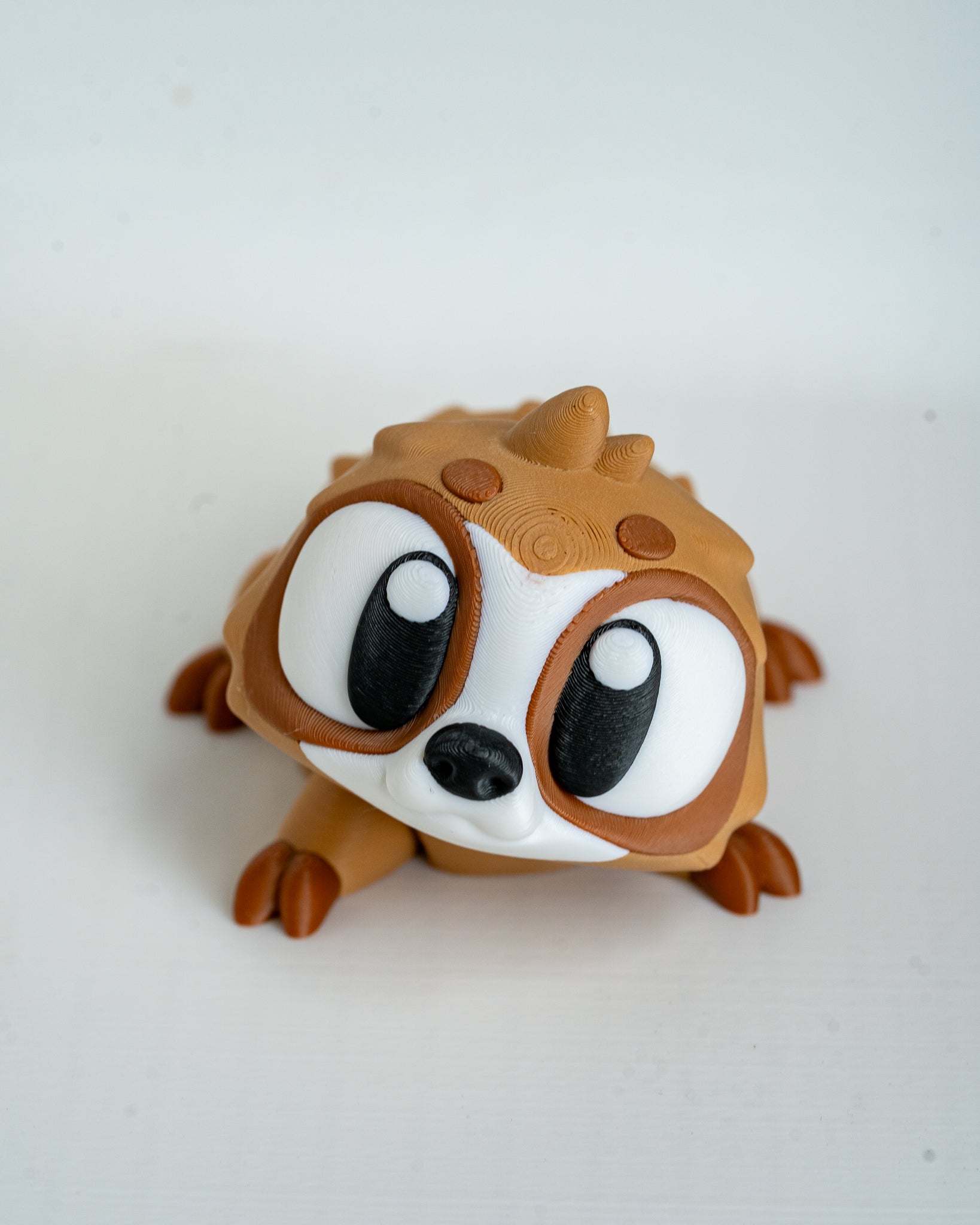 Mini sloth figurine with cartoon eyes