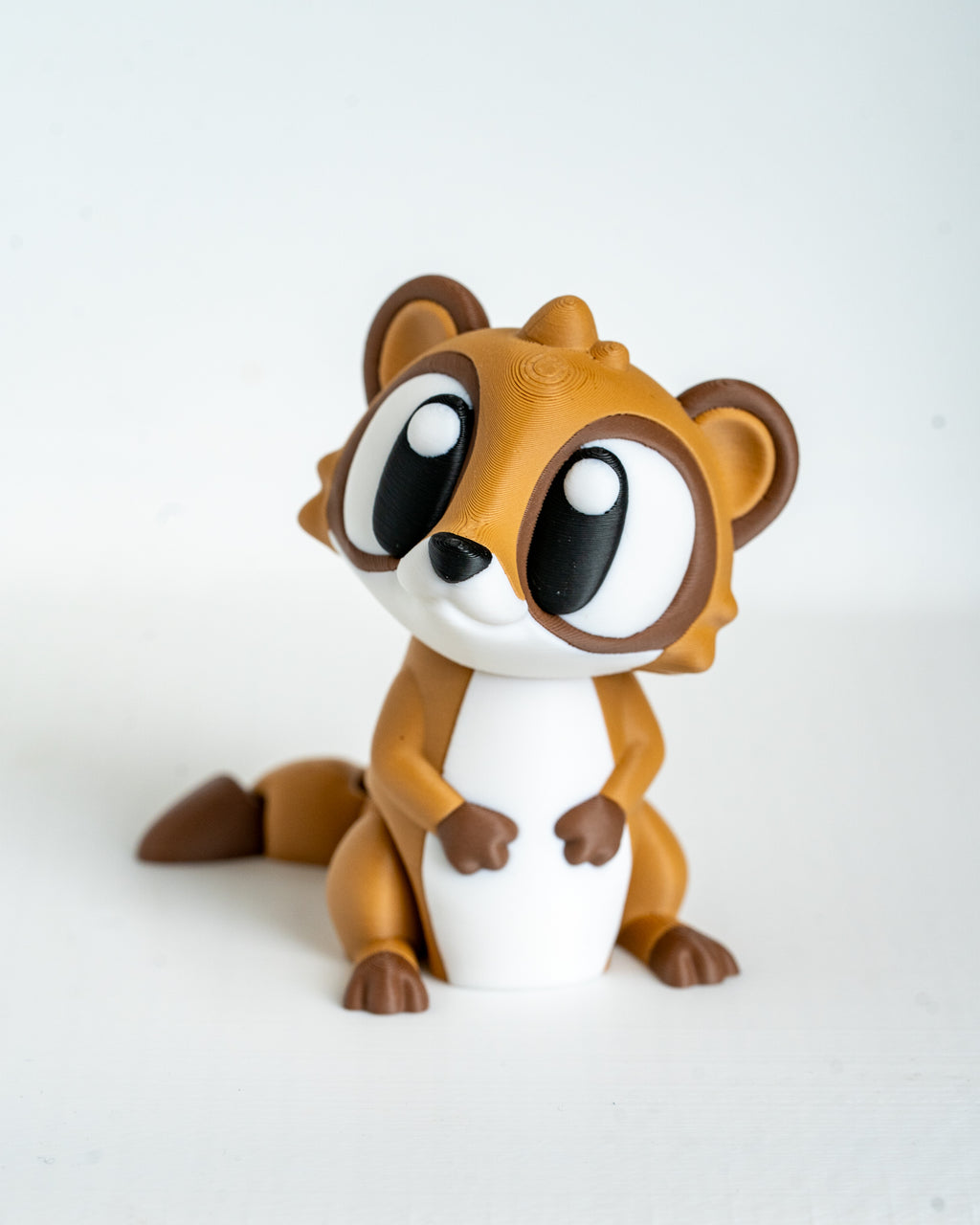 Mini meerkat figurine with cartoon eyes