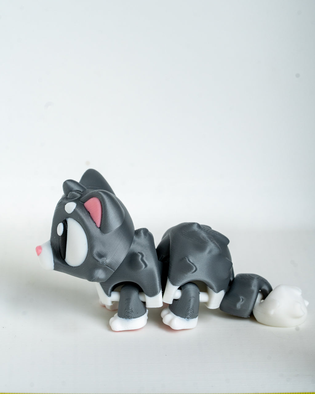 Mini cat figurine with cartoon eyes