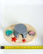 Underwater cave display base next to measuring tape for scale