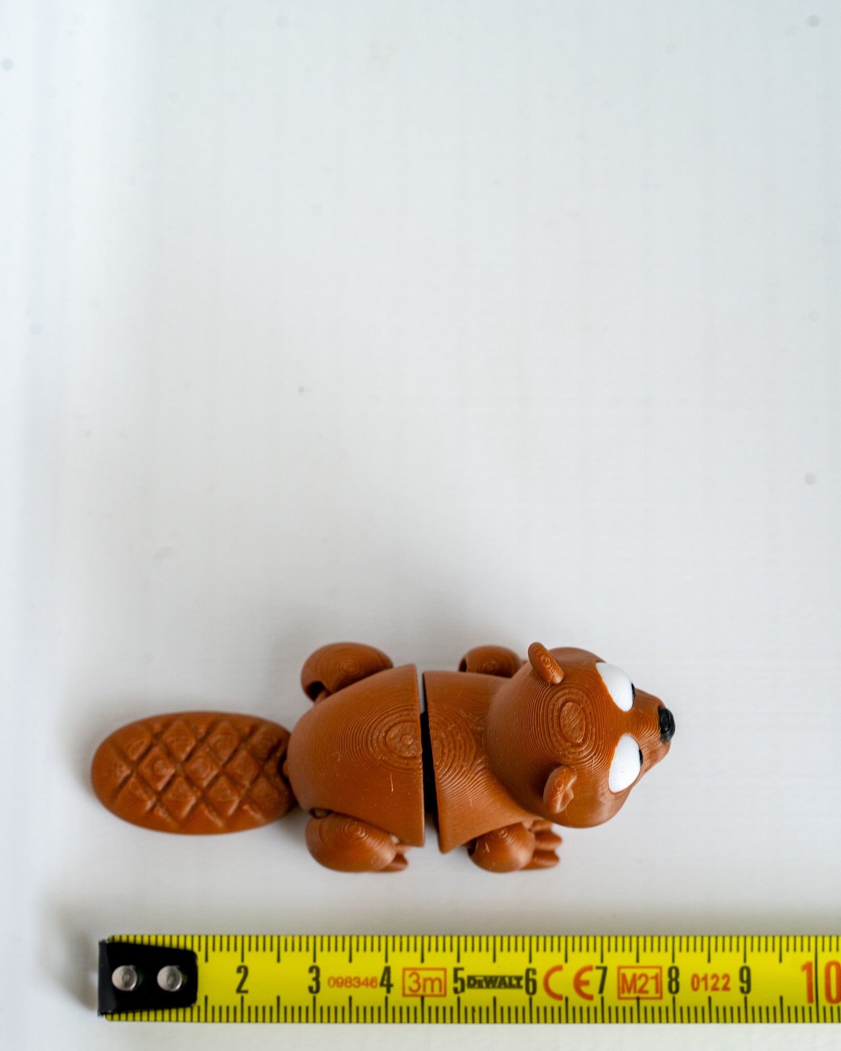 Beaver figure next to measuring tape for scale
