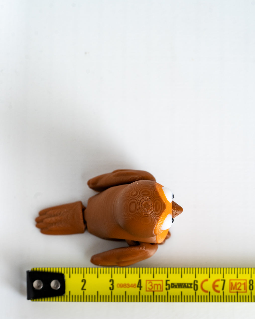Robin figure next to measuring tape for scale