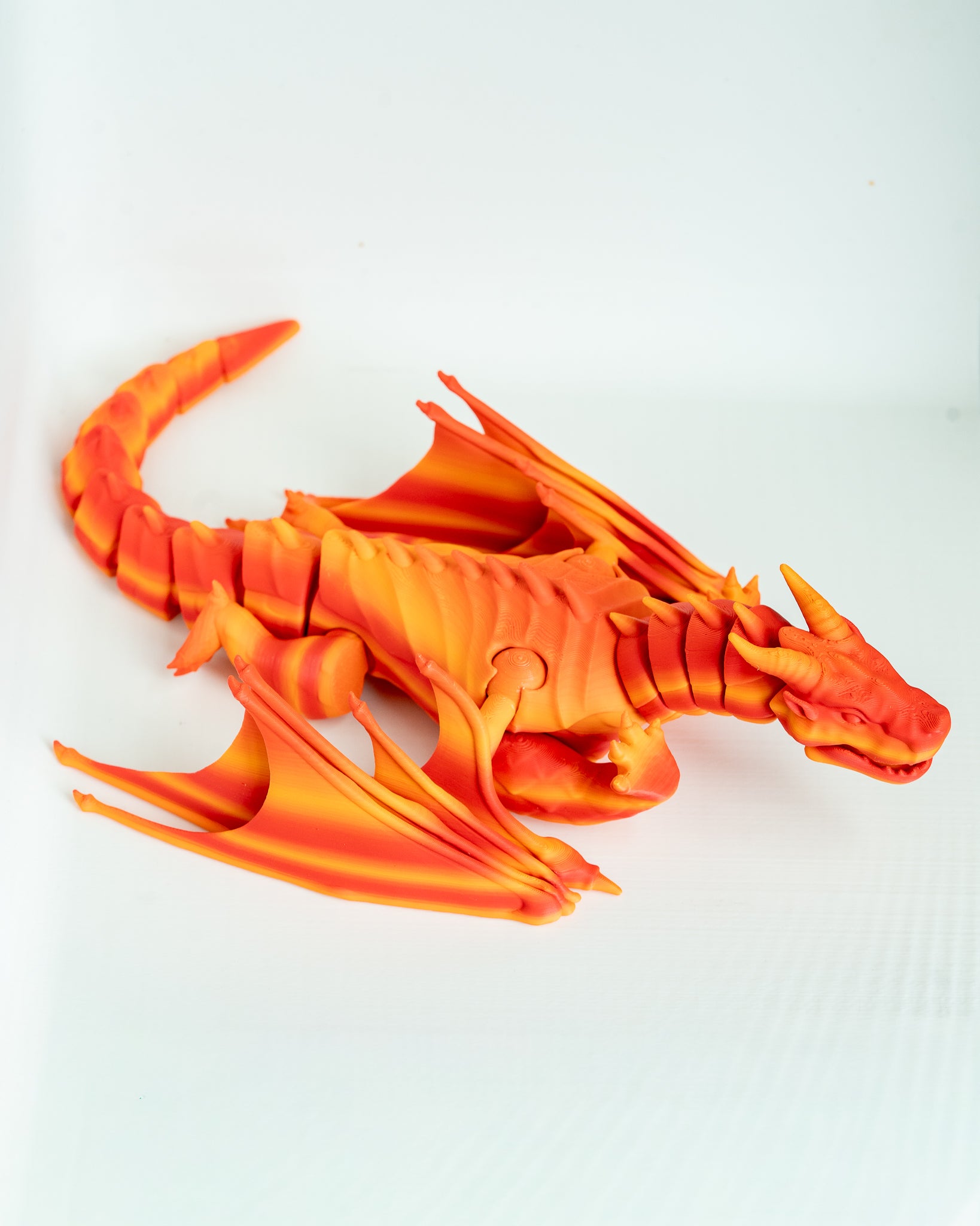 Orange dragon figure viewed from side
