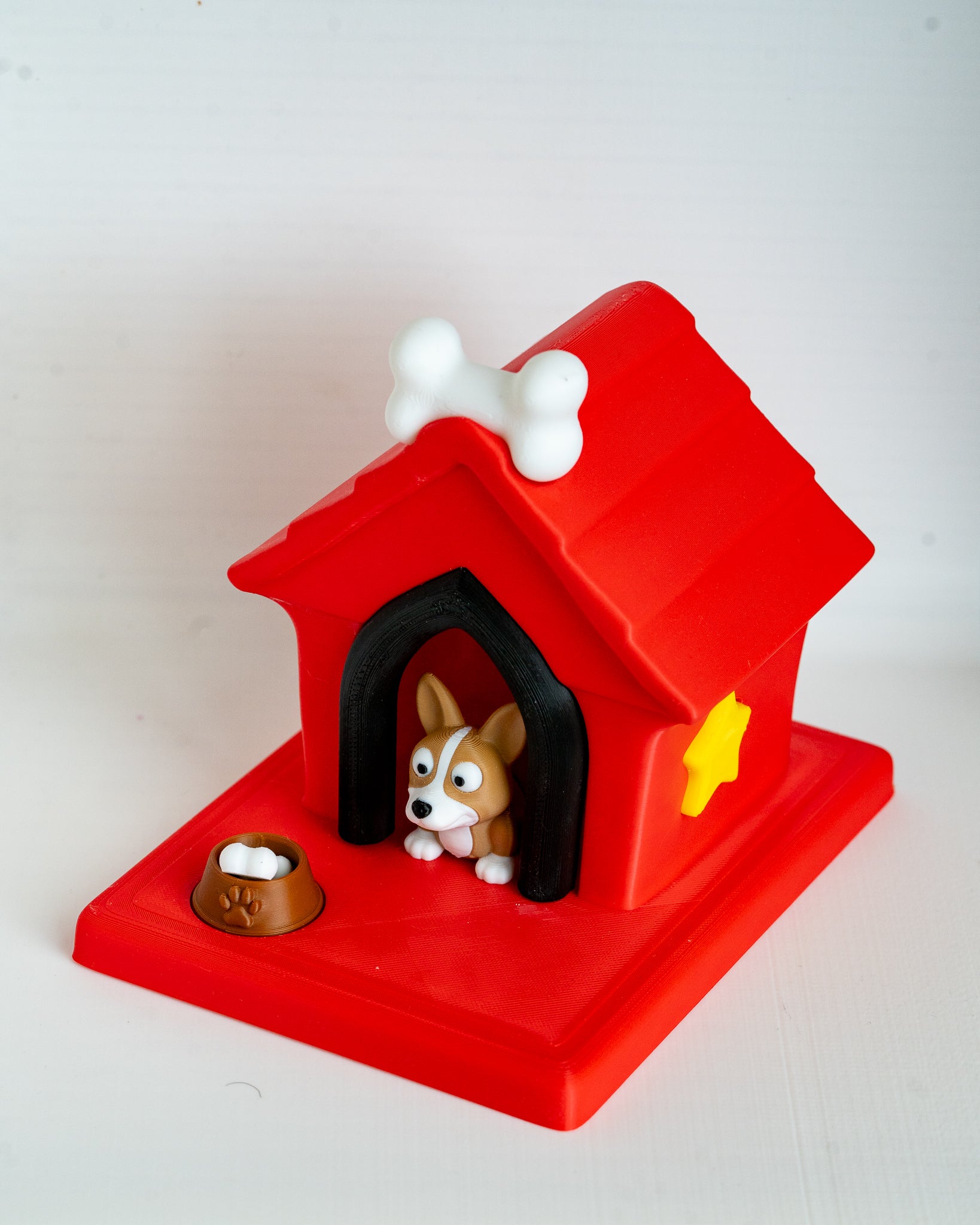 Dog house with corgi puppy figure inside