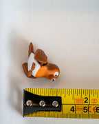 Robin figure next to measuring tape for scale