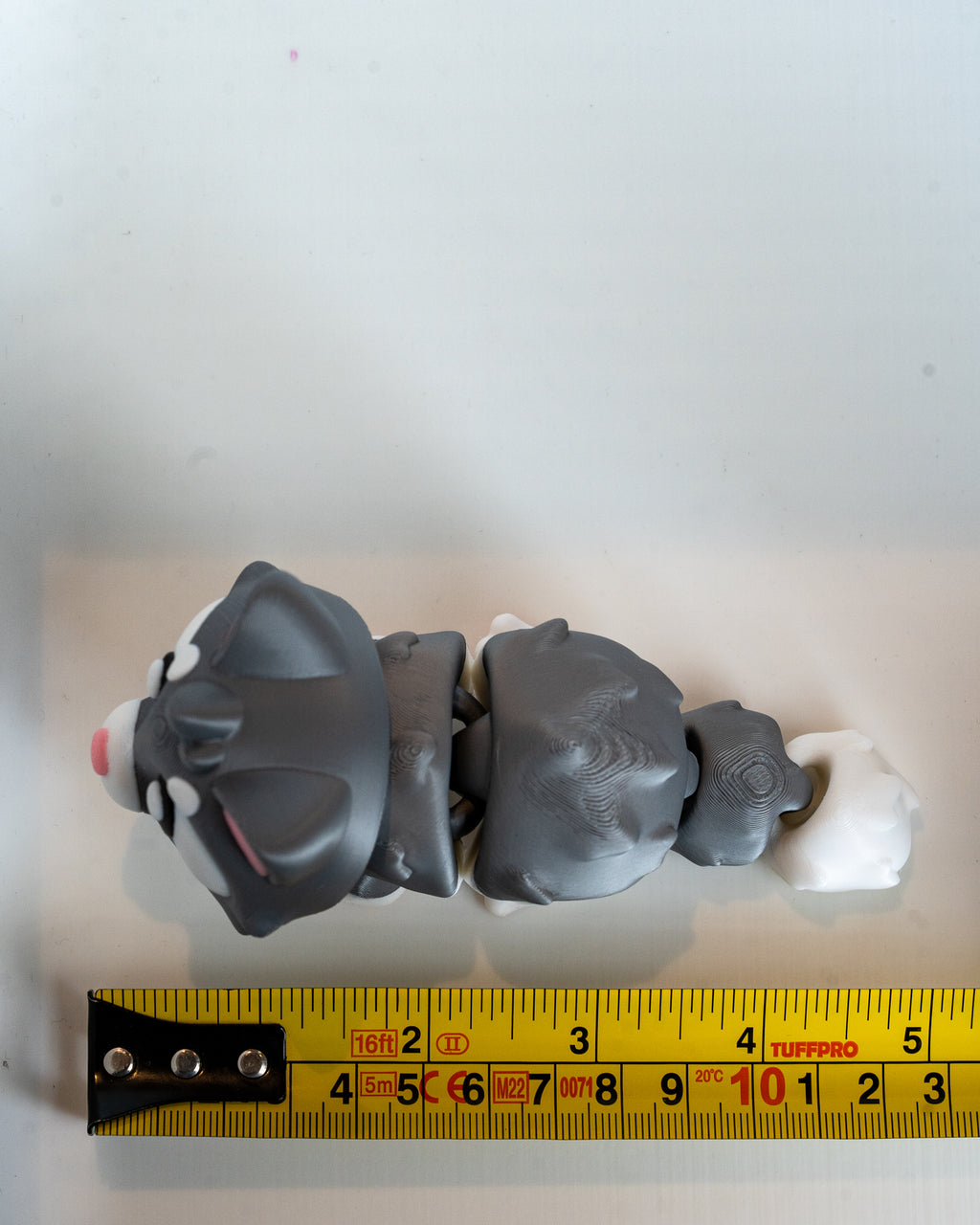 Cat figure next to measuring tape for scale