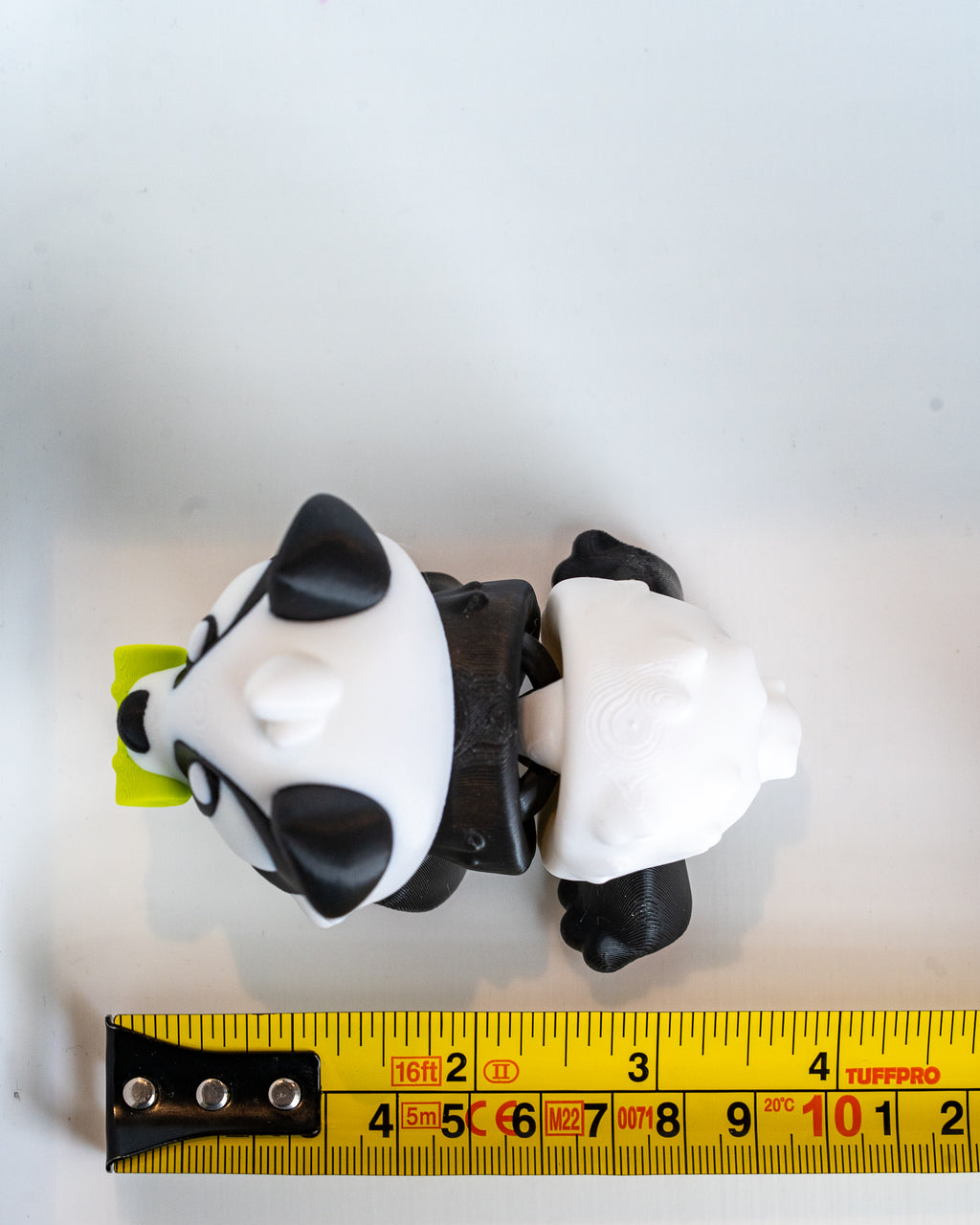 Panda figure next to measuring tape for scale