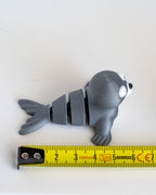 seal figurine with a measuring tape for scale 