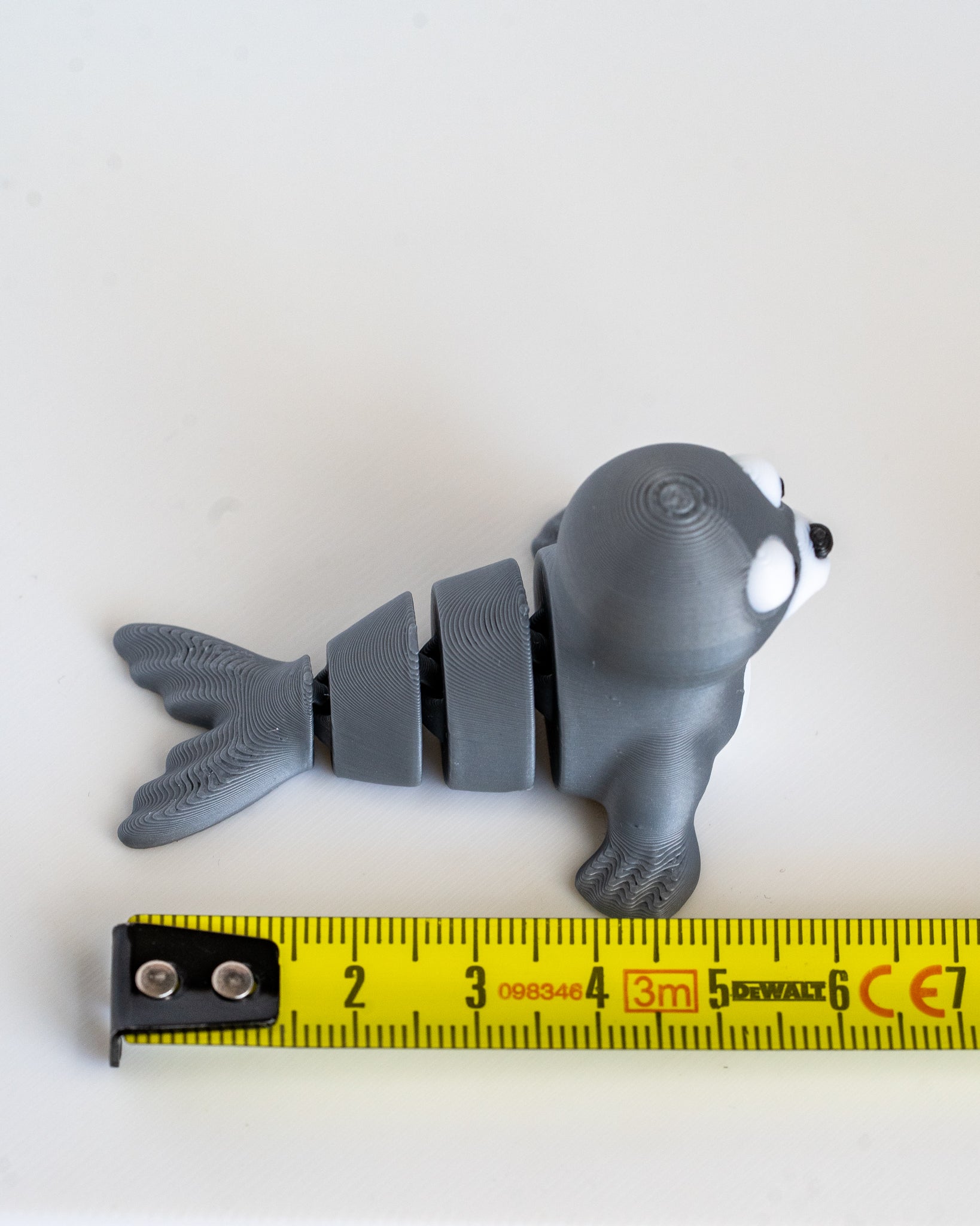 seal figurine with a measuring tape for scale 