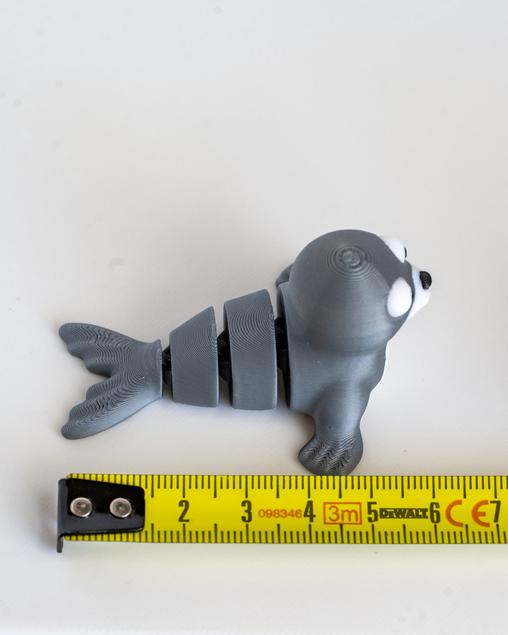 Seal figure next to measuring tape for scale