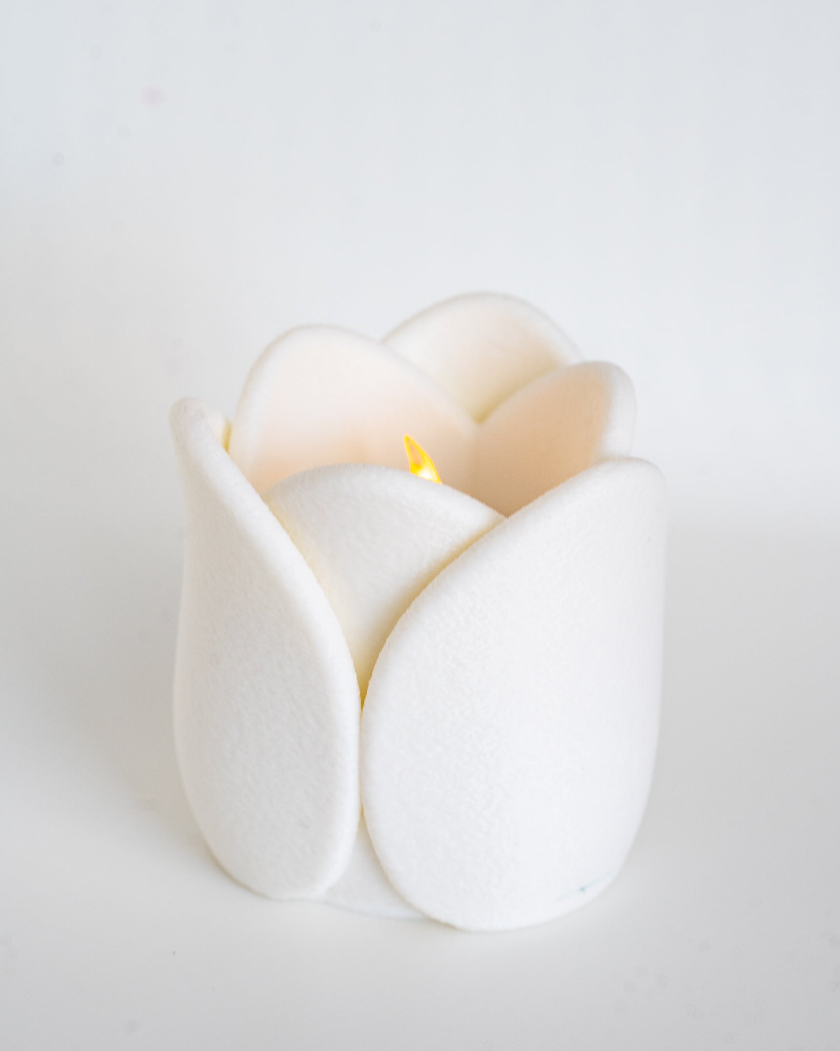 White tulip tealight holder viewed from side