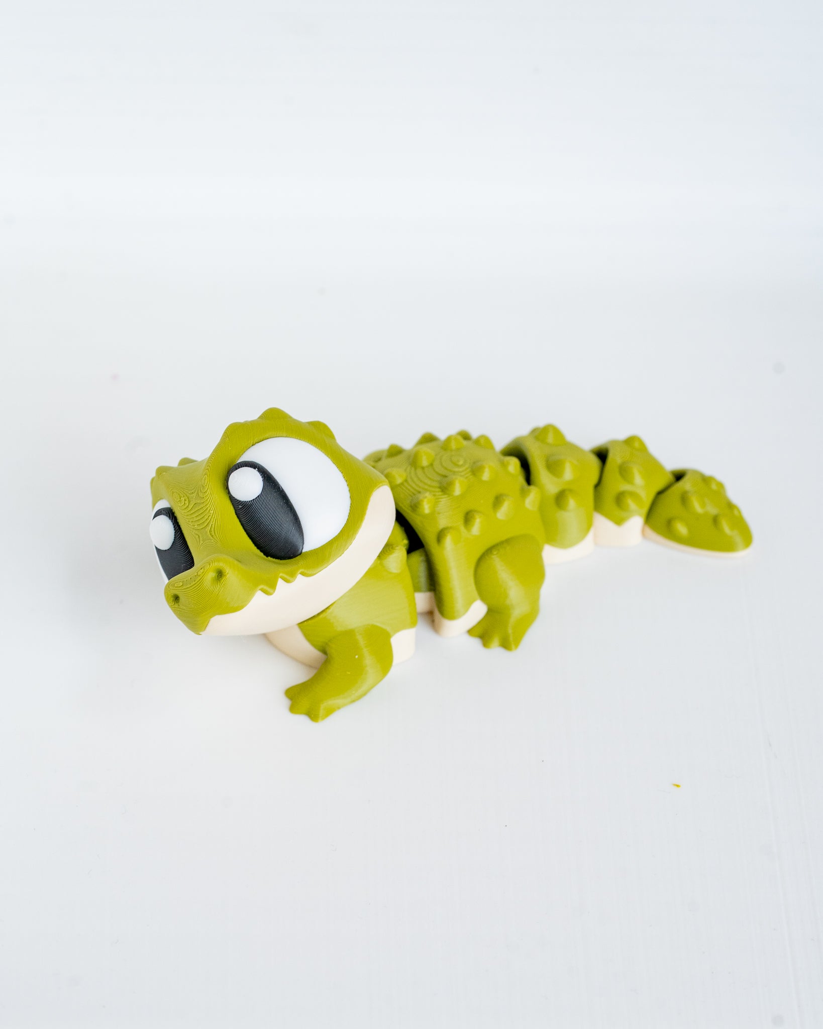 Articulated crocodile figurine with cartoon eyes