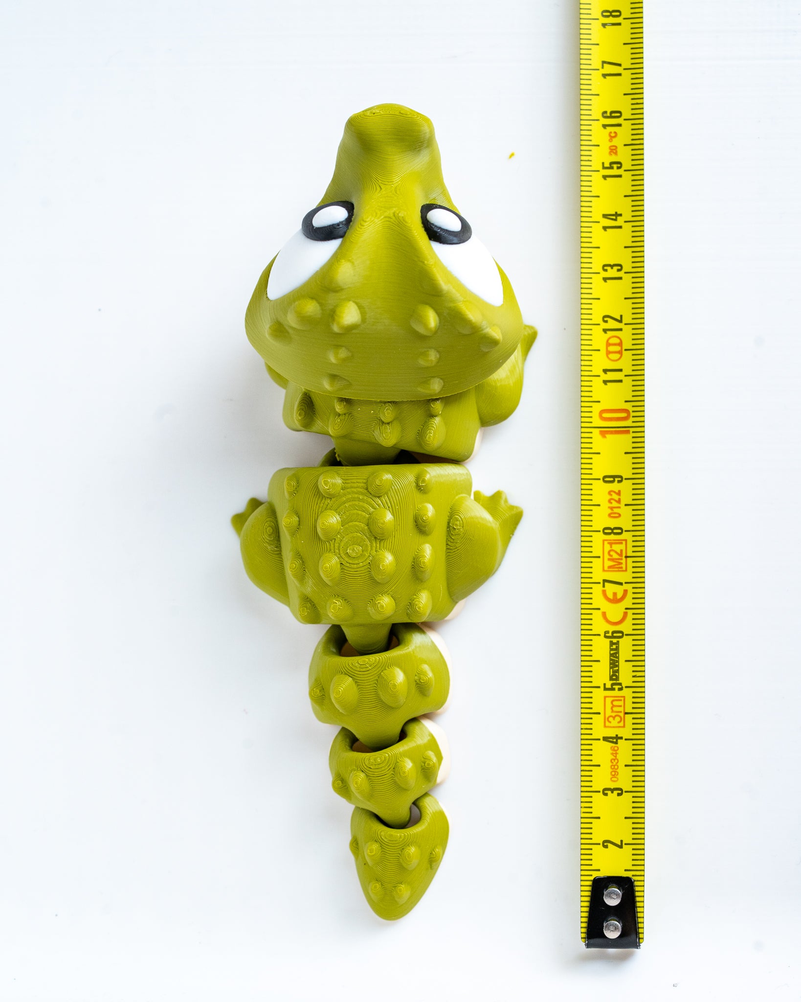 Crocodile figure next to measuring tape for scale