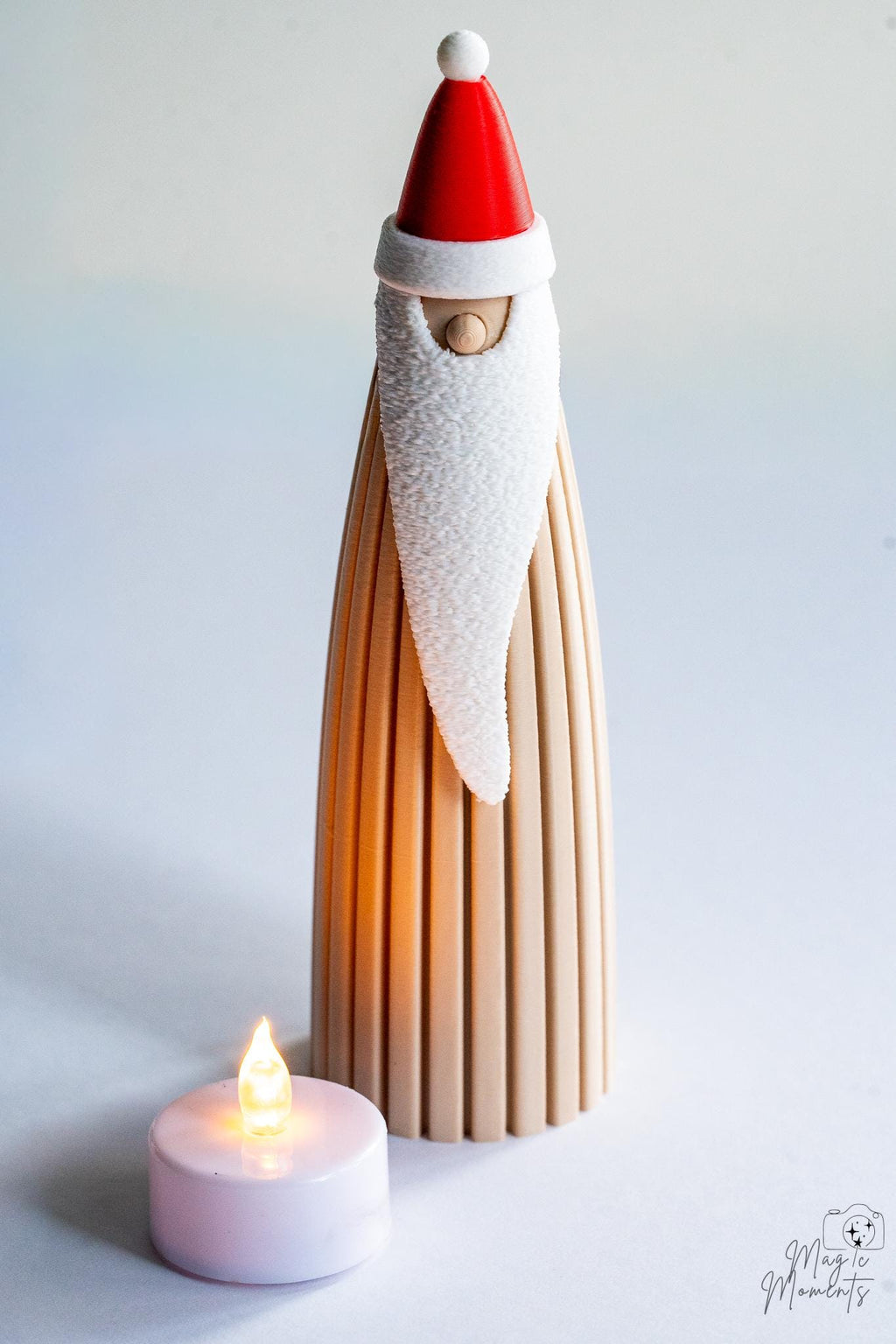 Santa decoration with LED tealight candle beside display