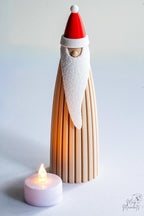 Santa decoration with LED tealight candle beside display