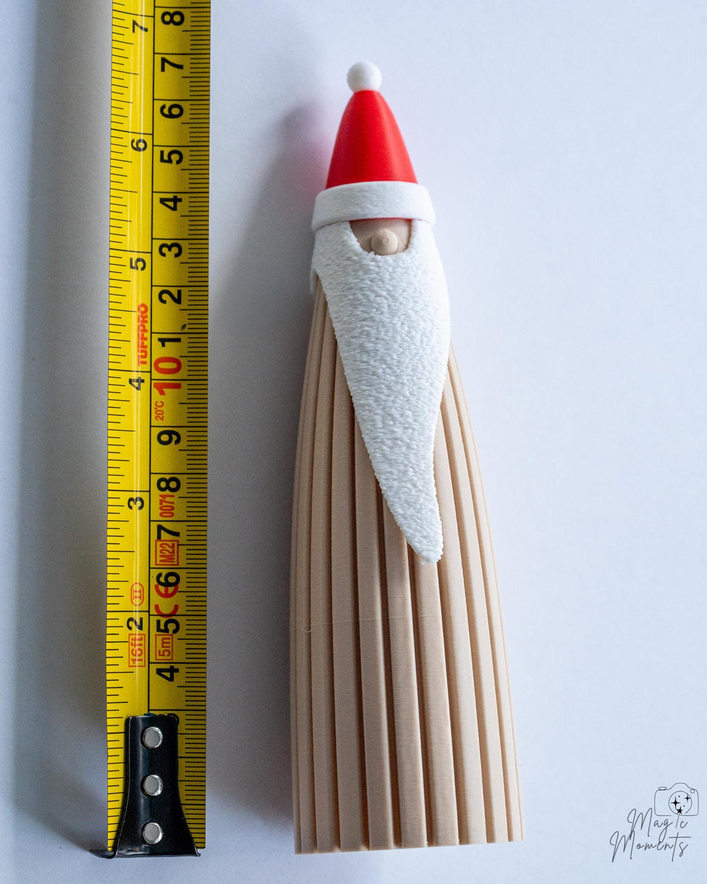 Santa decoration next to measuring tape for scale