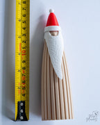 Santa decoration next to measuring tape for scale
